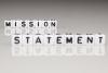 Schriftzug Mission Statement aus Buchstabenwürfel zusammengesetzt